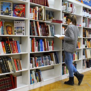 A girl reading book in library
